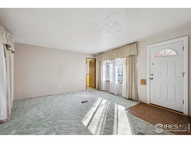 a view of an empty room and window