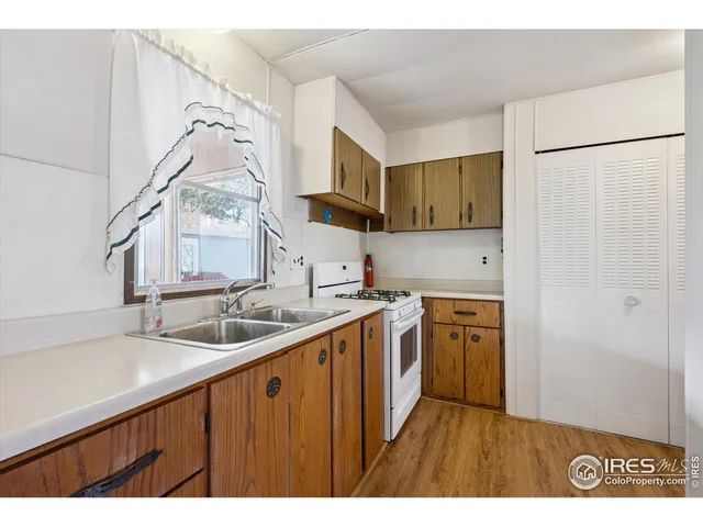 a kitchen with stainless steel appliances granite countertop a sink and a refrigerator