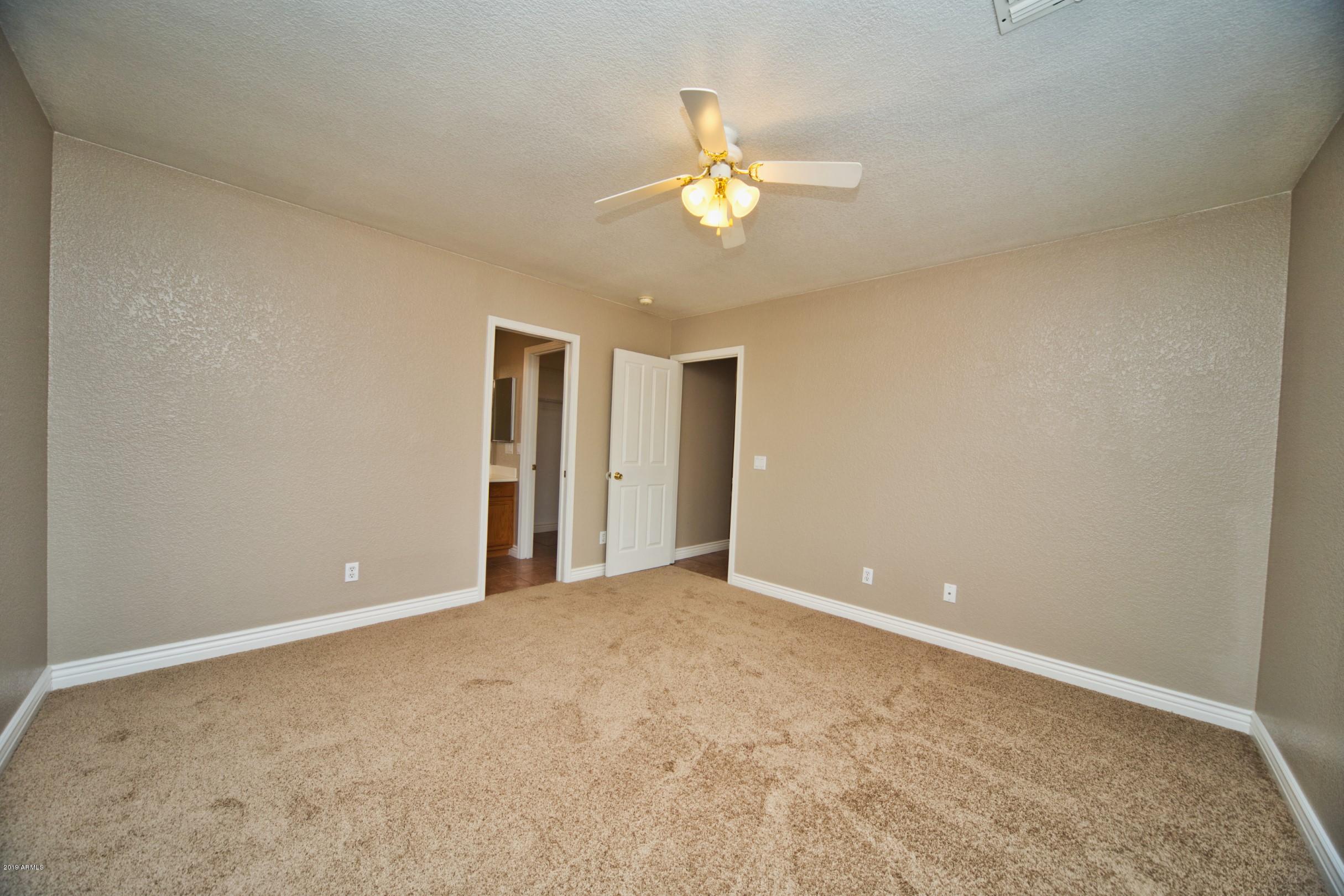 6237 West Raymond Street Phoenix, AZ 85043 - Photo 16 of 39 a view of an empty room with a chandelier fan