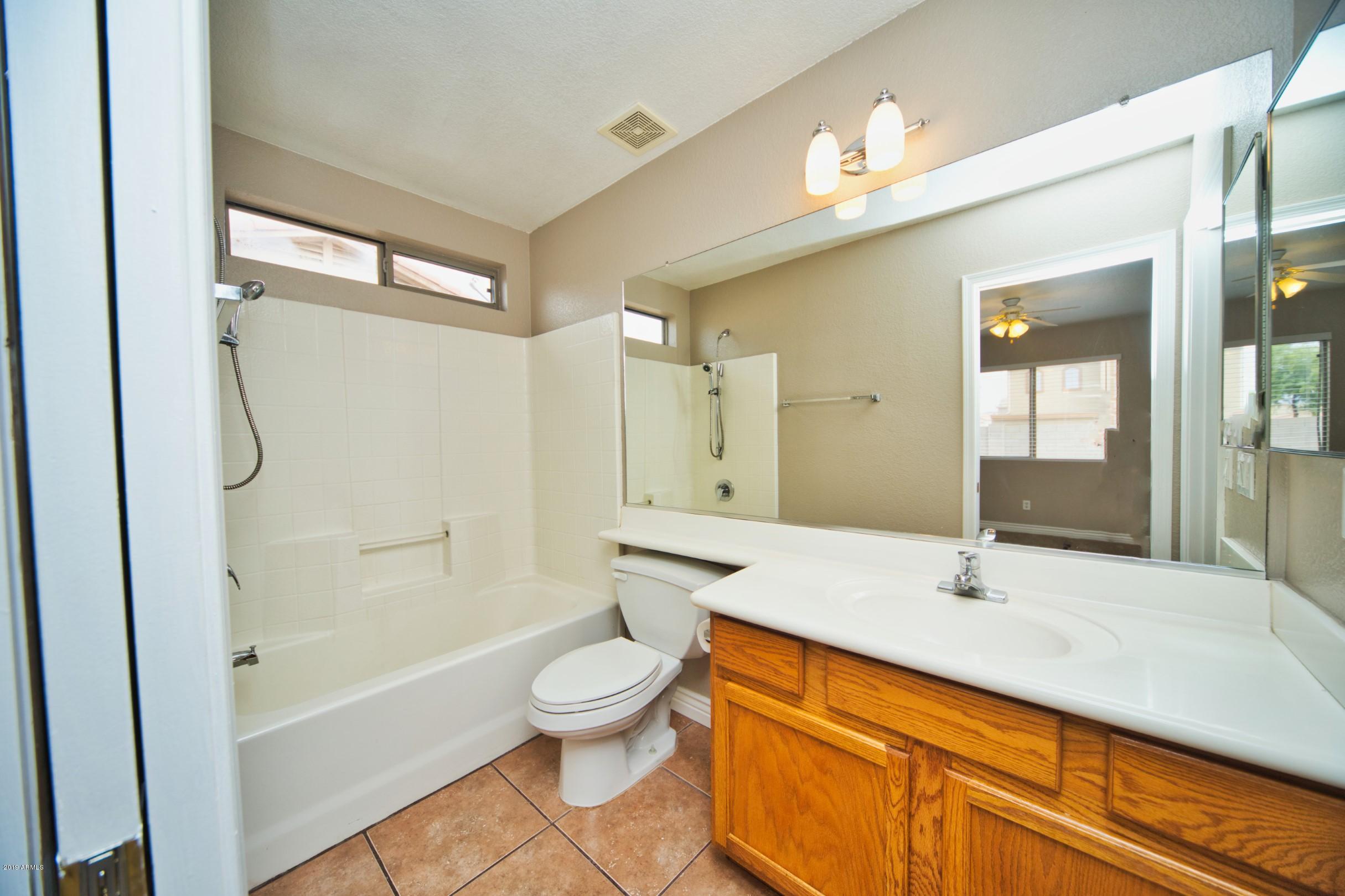 6237 West Raymond Street Phoenix, AZ 85043 - Photo 18 of 39 a bathroom with a sink a toilet and shower