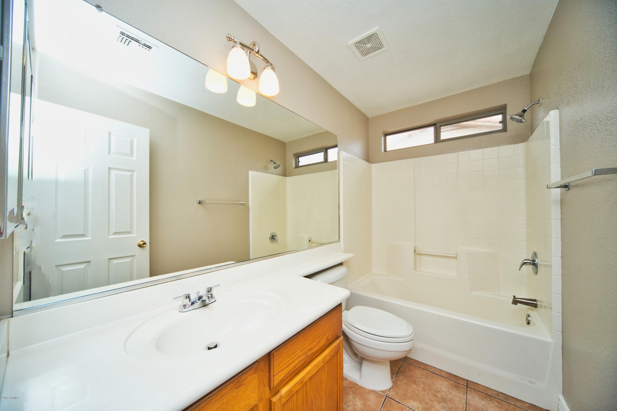 6237 West Raymond Street Phoenix, AZ 85043 - Photo 25 of 39 a bathroom with a sink a toilet and shower