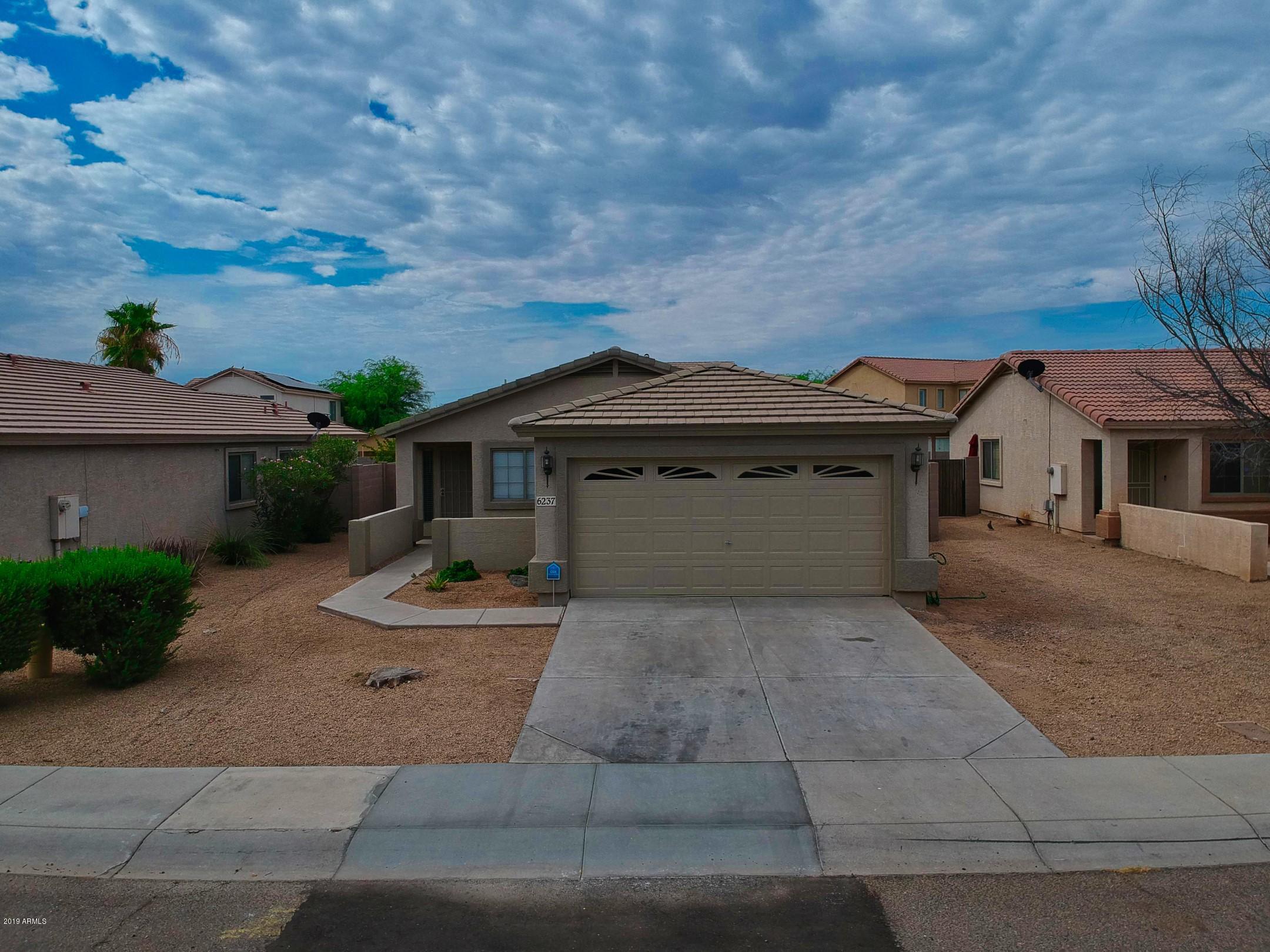 6237 West Raymond Street Phoenix, AZ 85043 - Photo 32 of 39 a front view of a house with a yard and garage