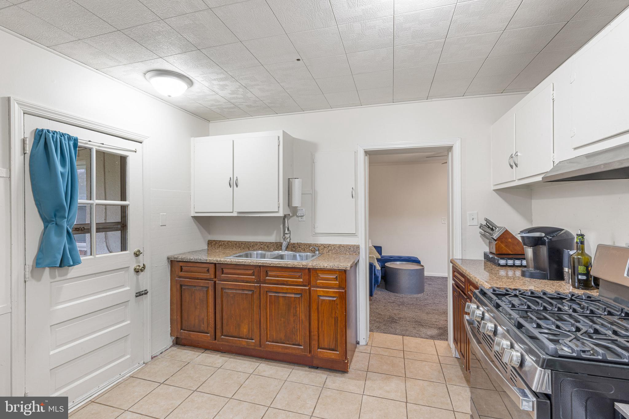 422 Elmwood Road Baltimore, MD 21206 - Photo 11 of 29 a kitchen with a sink and cabinets