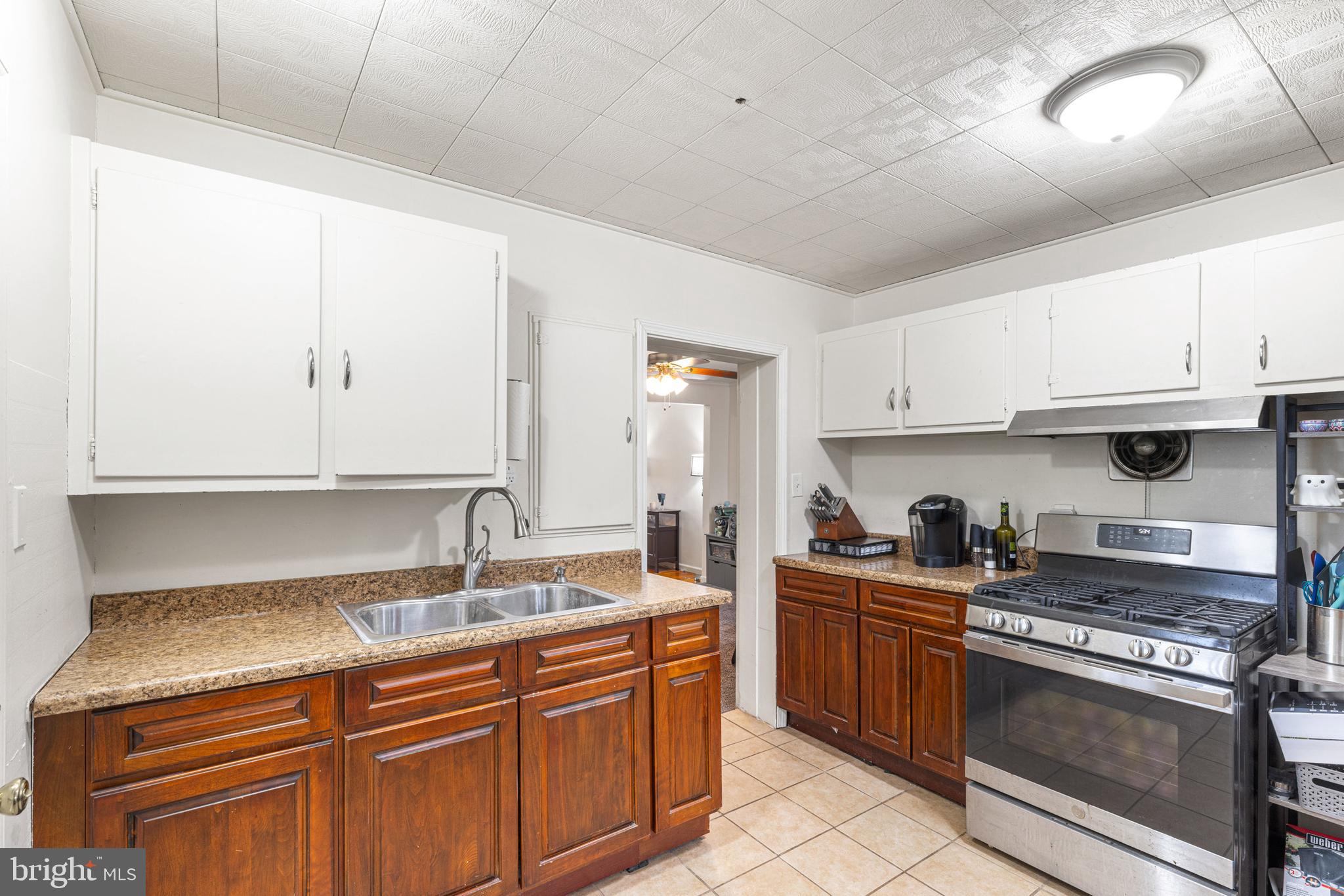 422 Elmwood Road Baltimore, MD 21206 - Photo 13 of 29 a kitchen with stainless steel appliances granite countertop a sink stove and cabinets