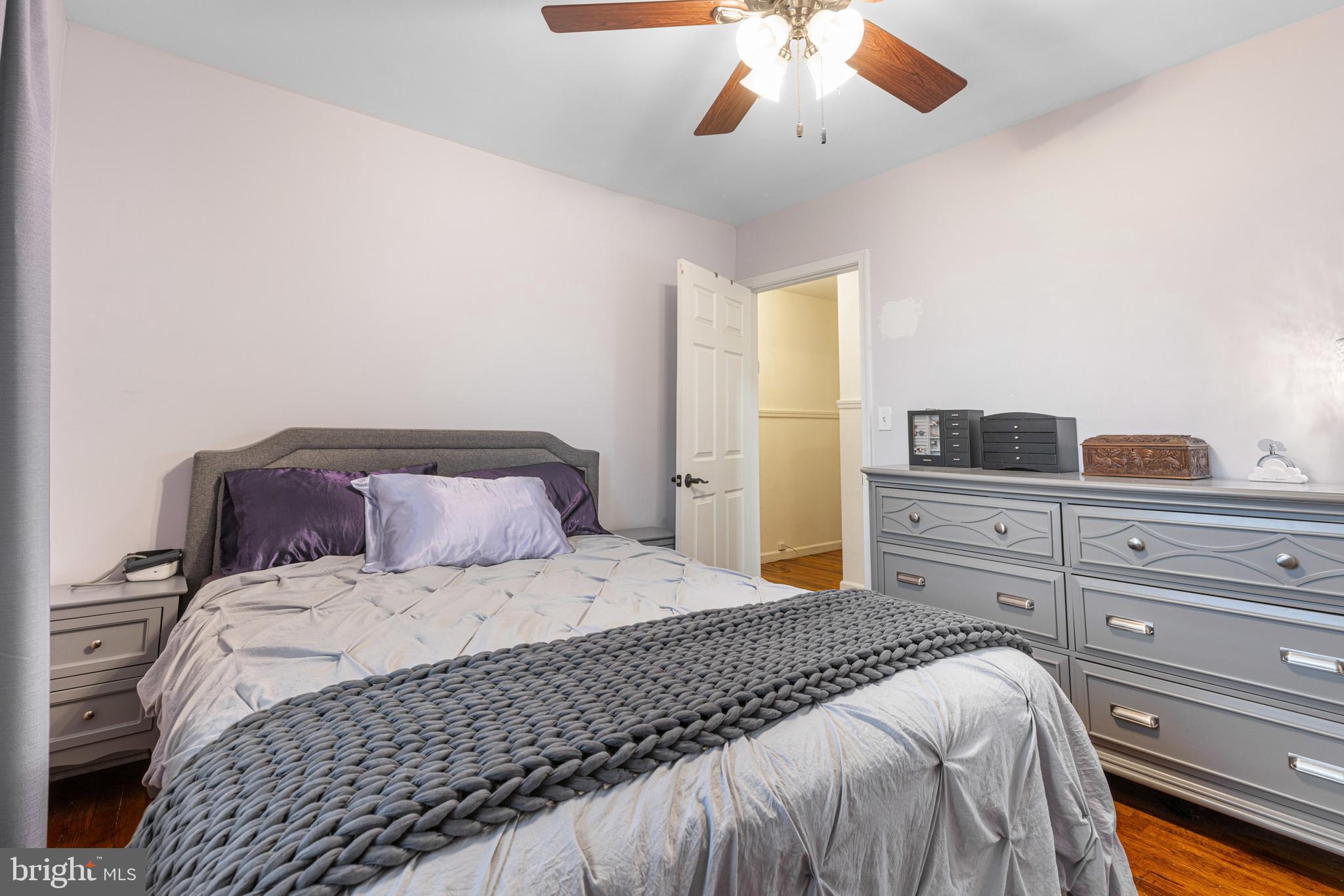 422 Elmwood Road Baltimore, MD 21206 - Photo 14 of 29 a bedroom with a large bed and a chandelier