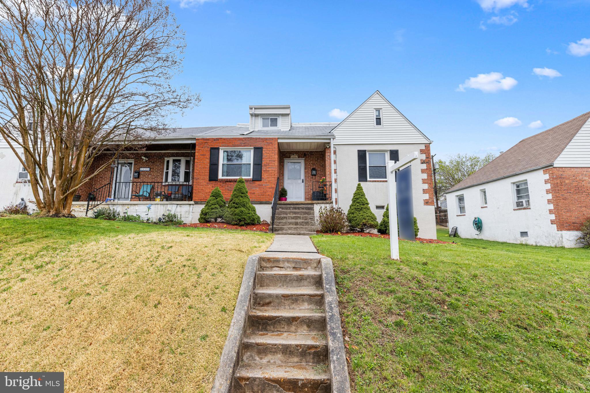 422 Elmwood Road Baltimore, MD 21206 - Photo 25 of 29 a front view of a house with a yard and potted plants