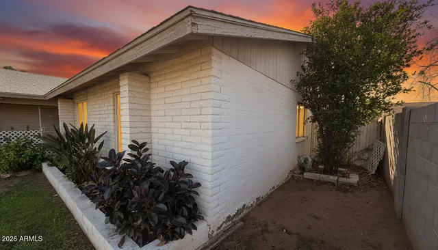 a house with a small yard and potted plants