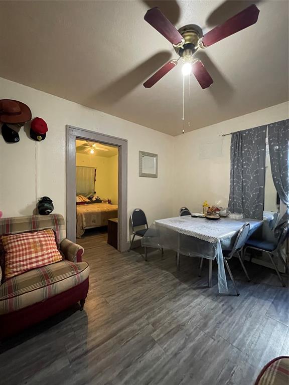 607 Neches Street Dallas, TX 75208 - Photo 11 of 12 a bedroom with furniture and a wooden floor