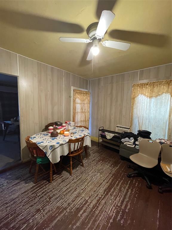 607 Neches Street Dallas, TX 75208 - Photo 3 of 12 a workspace with furniture window and wooden floor