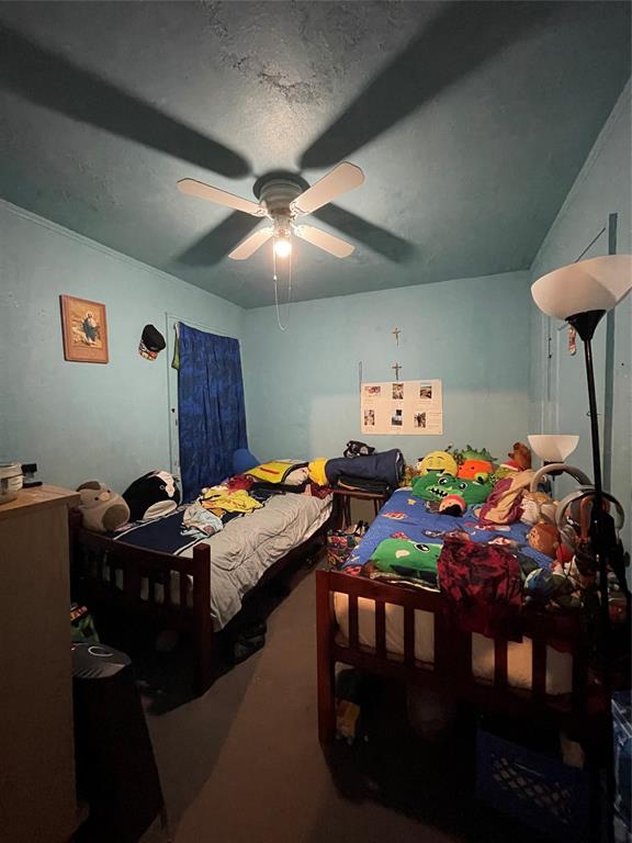 607 Neches Street Dallas, TX 75208 - Photo 7 of 12 a bedroom with furniture and a chandelier
