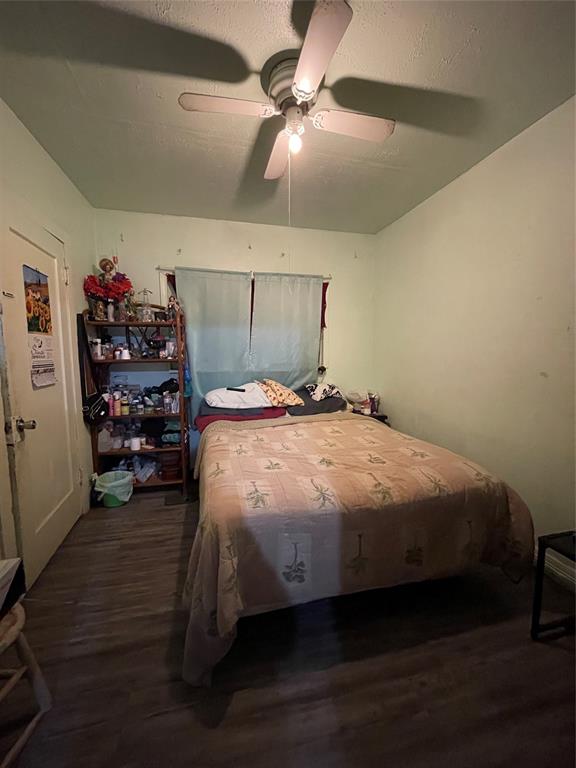 607 Neches Street Dallas, TX 75208 - Photo 10 of 12 a bedroom with a bed and a chandelier