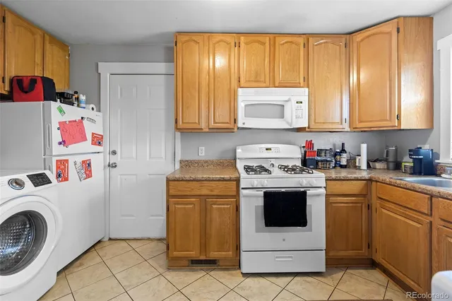 a kitchen with a stove top oven sink and cabinets