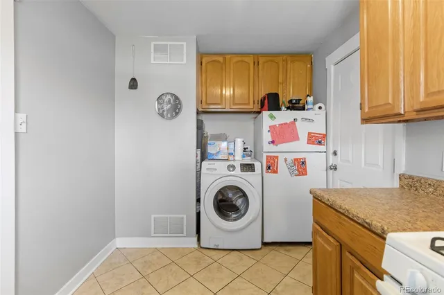 a utility room with sink dryer and washer