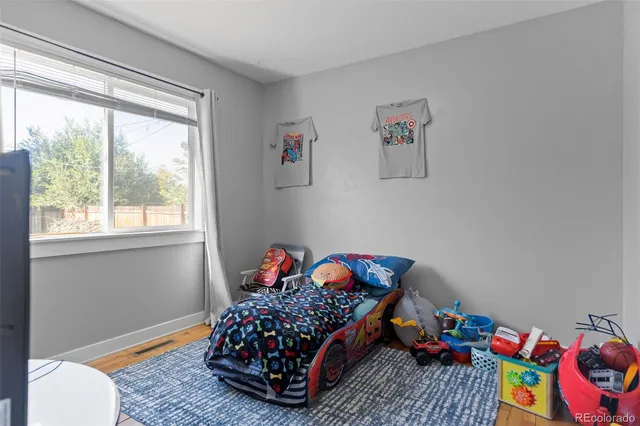 a bedroom with a bed and a dresser in it