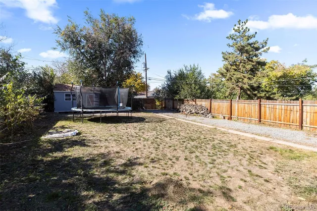 a view of a backyard with wooden fence