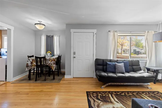 a living room with furniture and a dining table