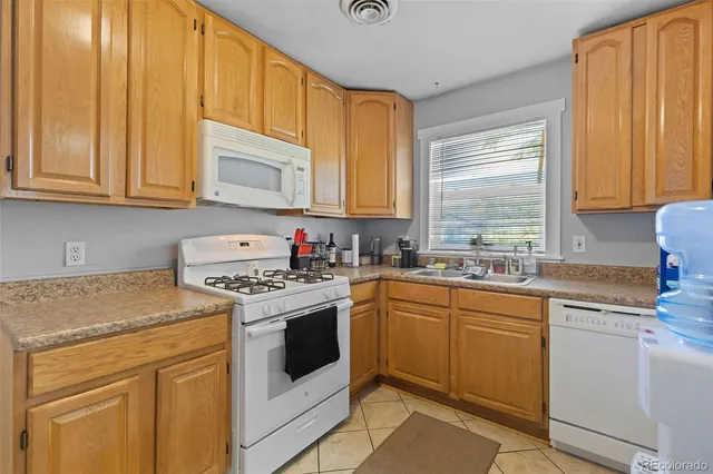 a kitchen with granite countertop cabinets stainless steel appliances and a sink