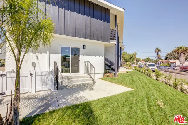 a view of a chair and table in the garden