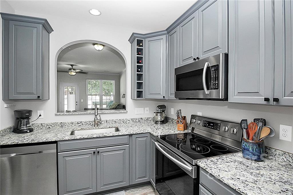 703 Shellstone Place Fort Mill, SC 29708 - Photo 5 of 23 a kitchen with stainless steel appliances granite countertop a sink stove and cabinets