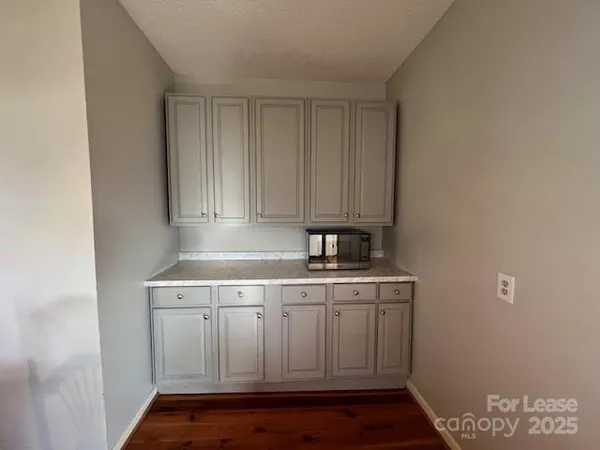 a kitchen with a sink cabinets and wooden floor