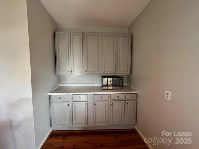a kitchen with a sink cabinets and wooden floor