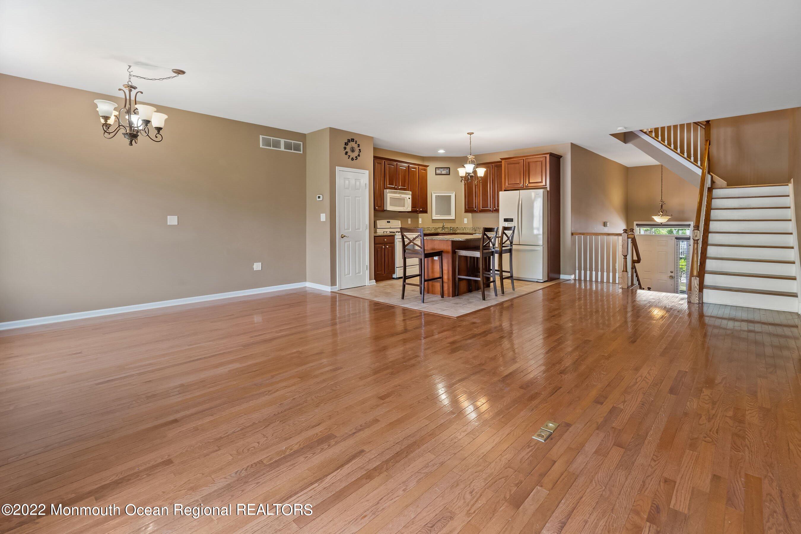 107 Bryce Lane, Unit 2004 Manahawkin, NJ 08050 - Photo 12 of 39 a view of a livingroom with furniture and wooden floor