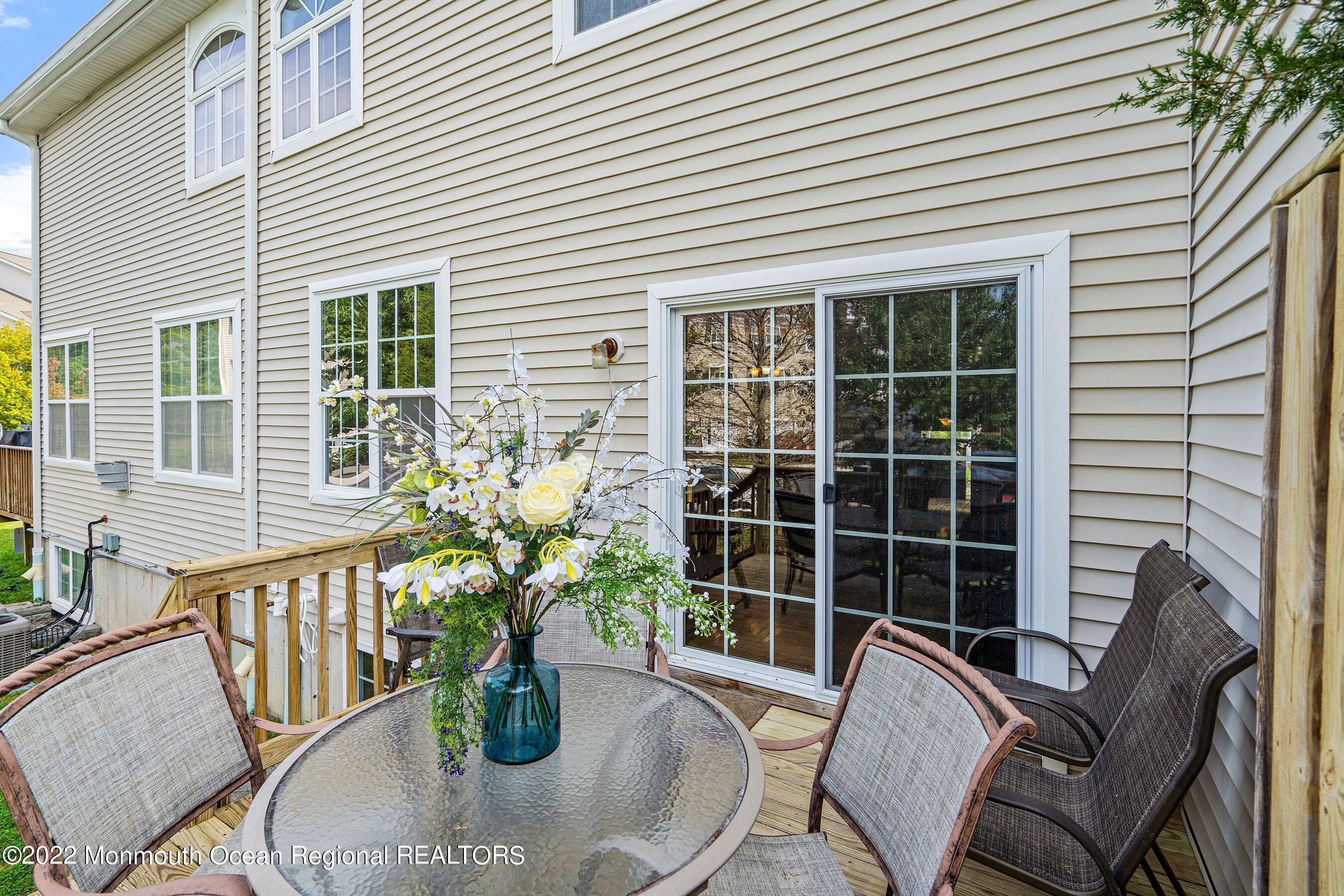 107 Bryce Lane, Unit 2004 Manahawkin, NJ 08050 - Photo 15 of 39 a view of balcony with couch and potted plant
