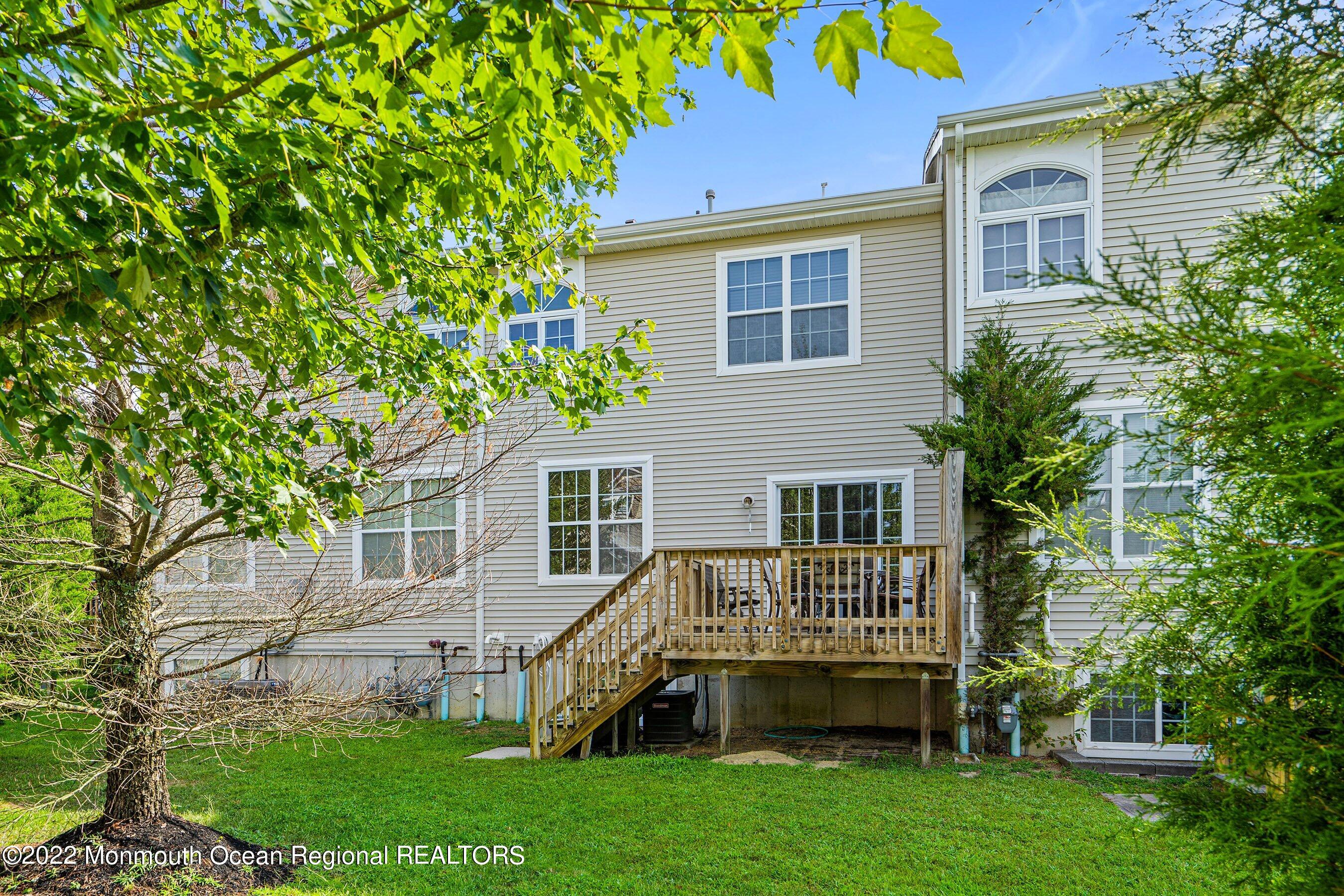 107 Bryce Lane, Unit 2004 Manahawkin, NJ 08050 - Photo 16 of 39 a view of a house with a yard