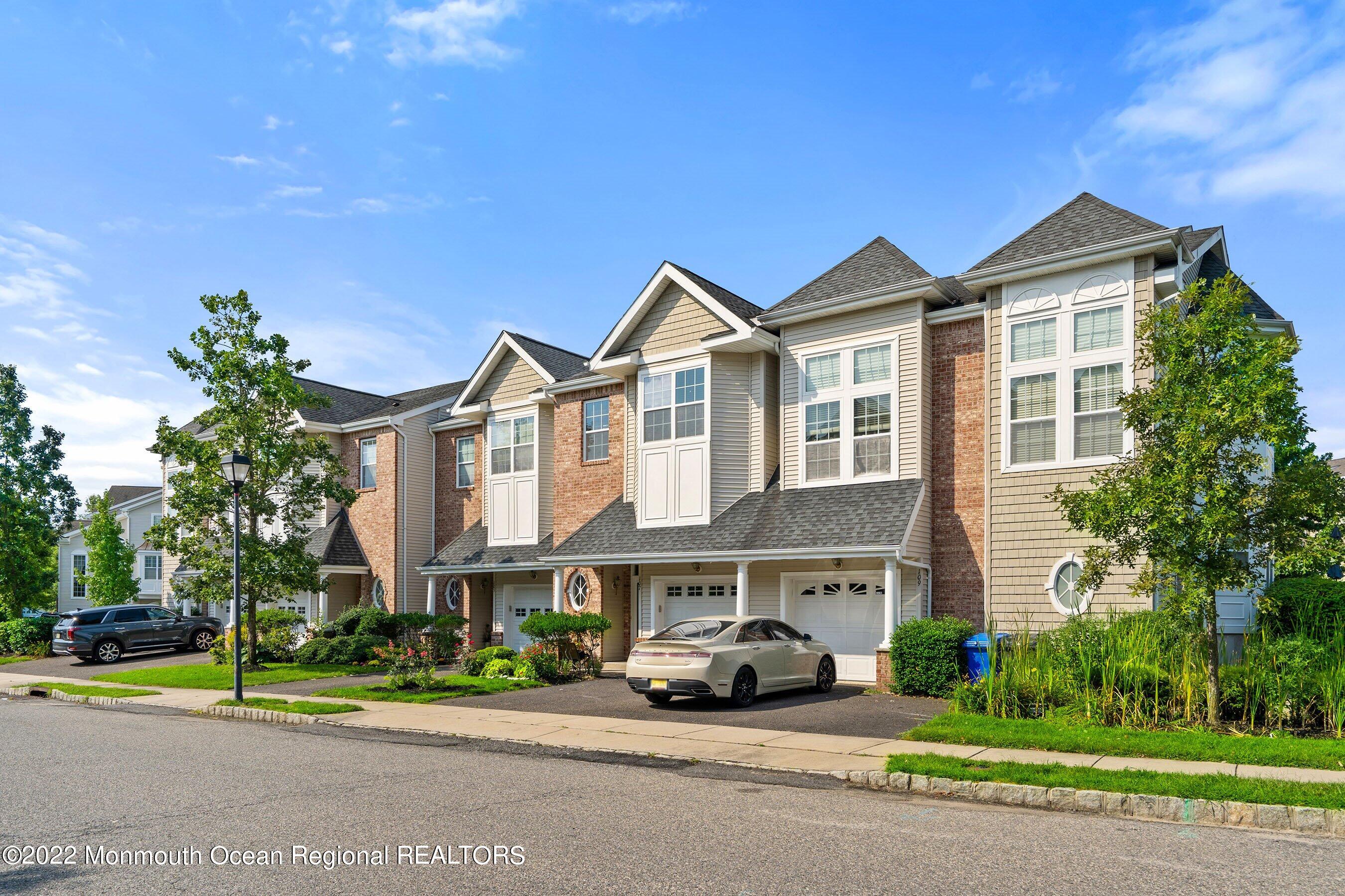 107 Bryce Lane, Unit 2004 Manahawkin, NJ 08050 - Photo 2 of 39 a car parked in front of a white house