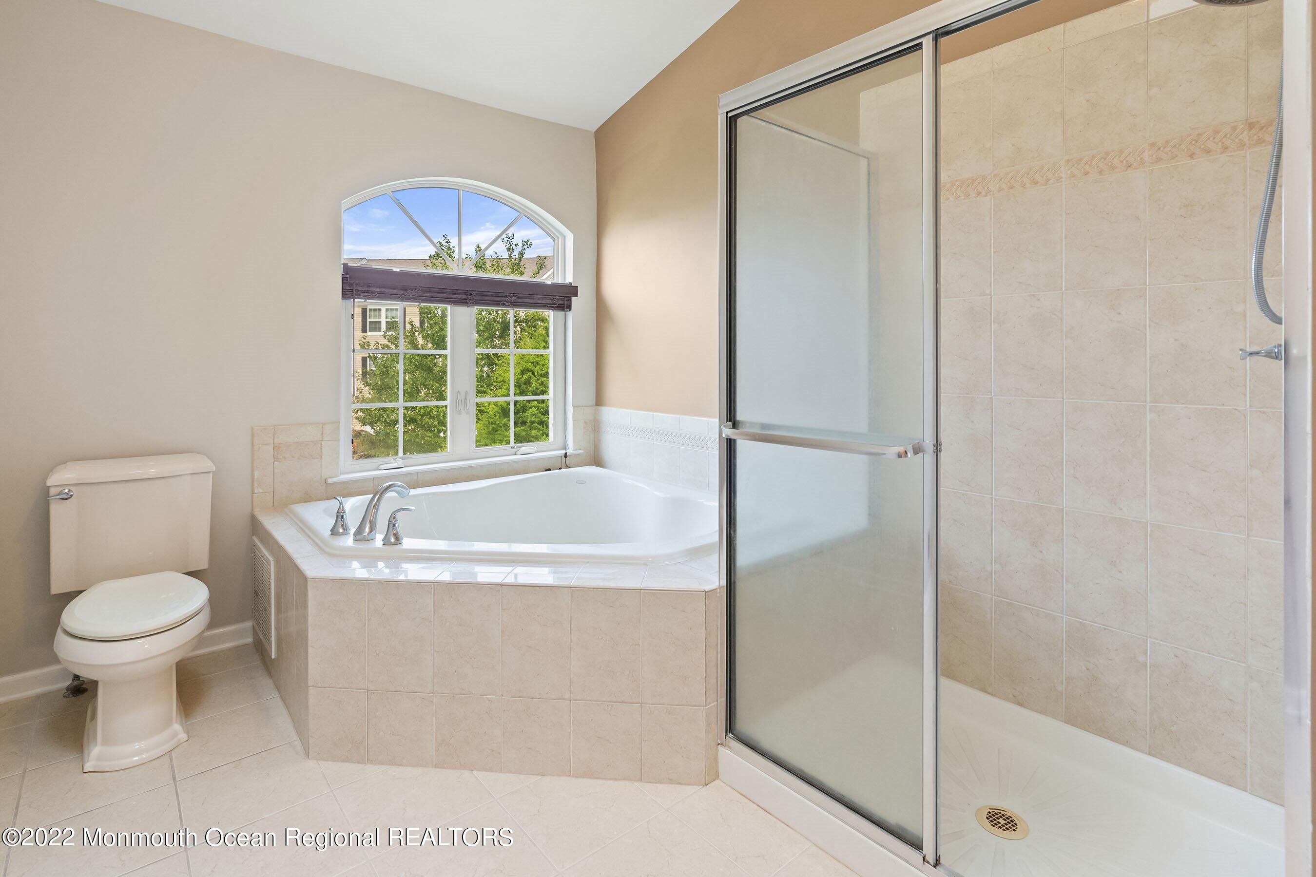 107 Bryce Lane, Unit 2004 Manahawkin, NJ 08050 - Photo 22 of 39 a bathroom with a toilet and a shower
