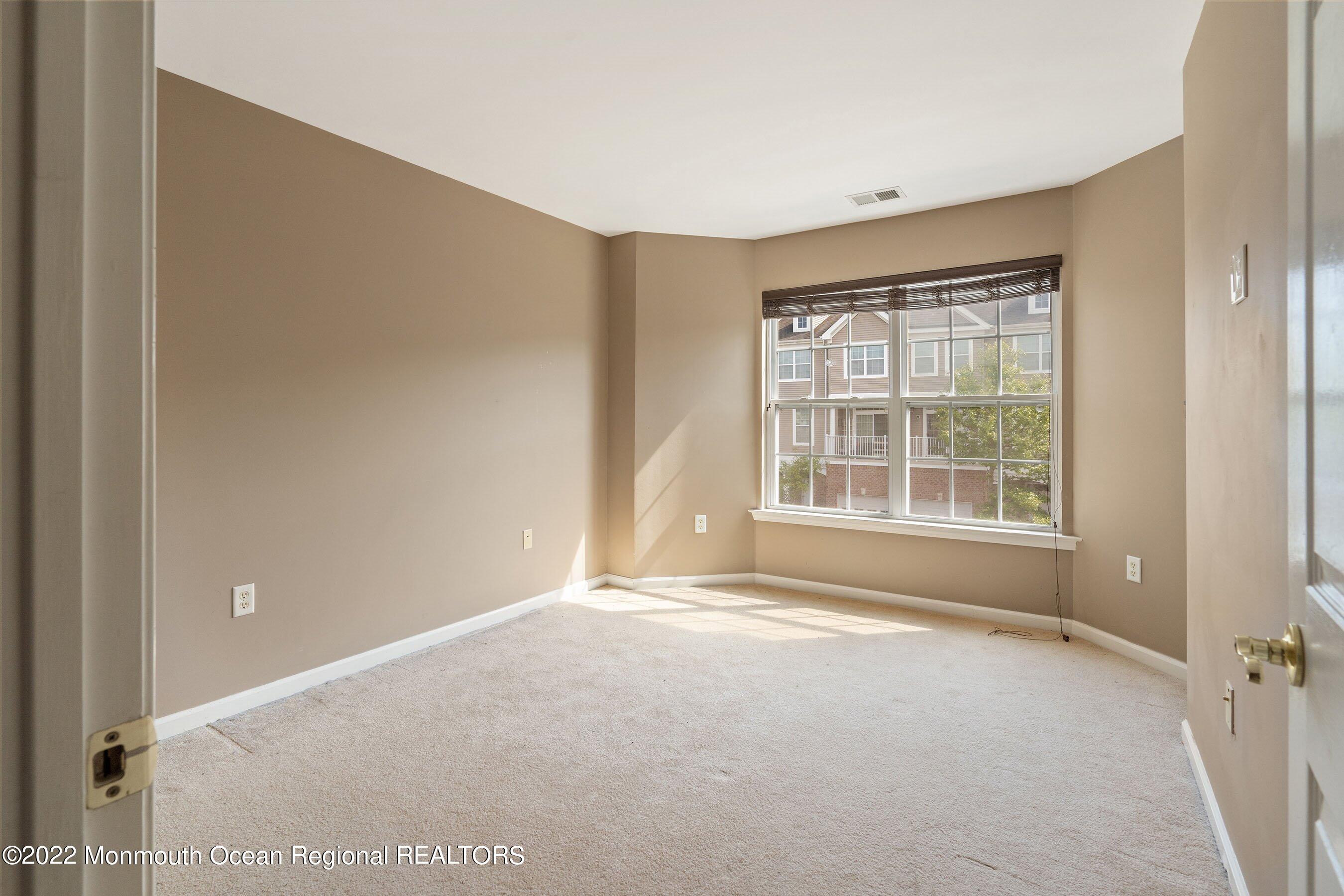 107 Bryce Lane, Unit 2004 Manahawkin, NJ 08050 - Photo 24 of 39 a view of an empty room with a window