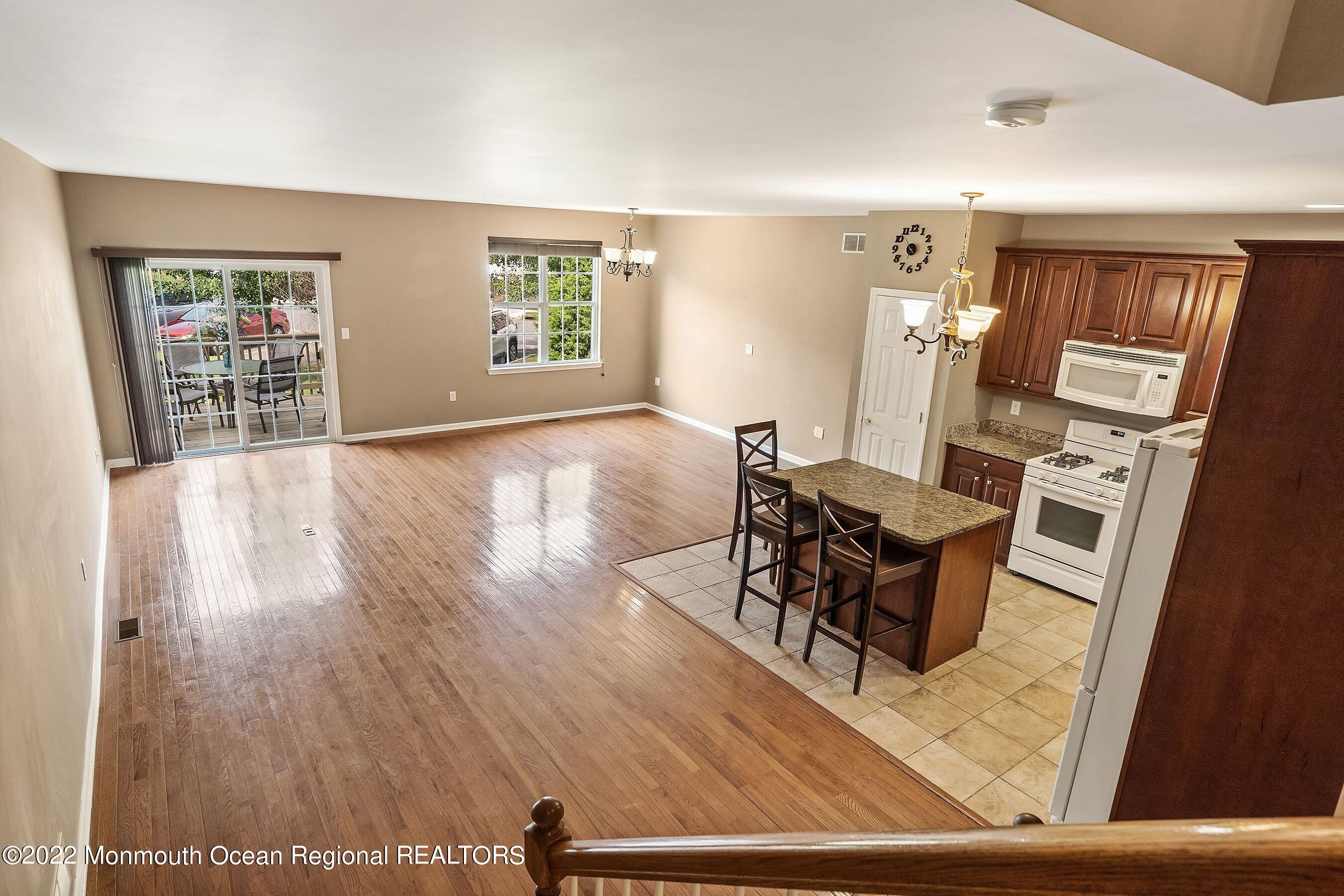 107 Bryce Lane, Unit 2004 Manahawkin, NJ 08050 - Photo 29 of 39 a living room with furniture and a window
