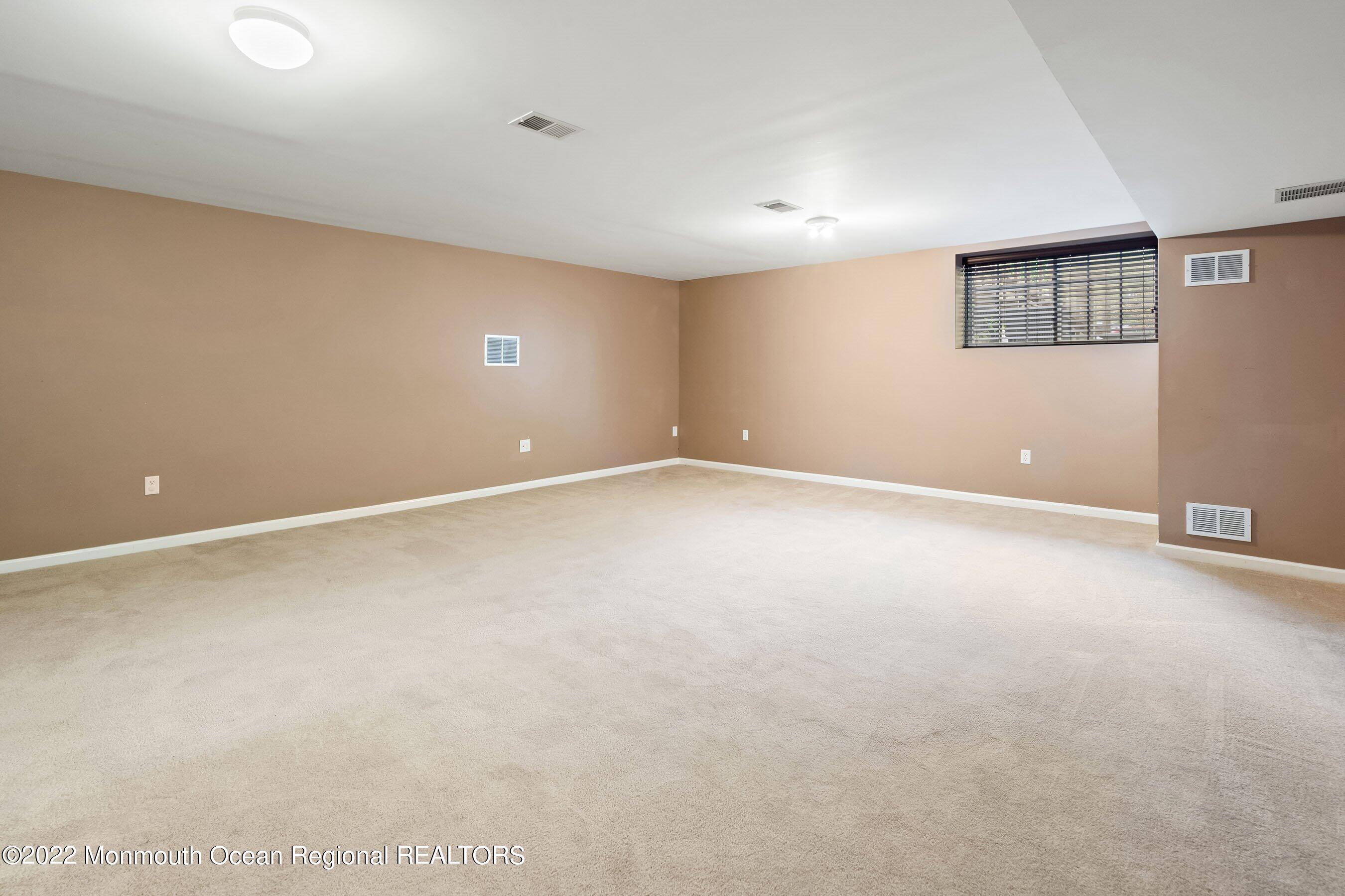107 Bryce Lane, Unit 2004 Manahawkin, NJ 08050 - Photo 31 of 39 a view of an empty room with a window