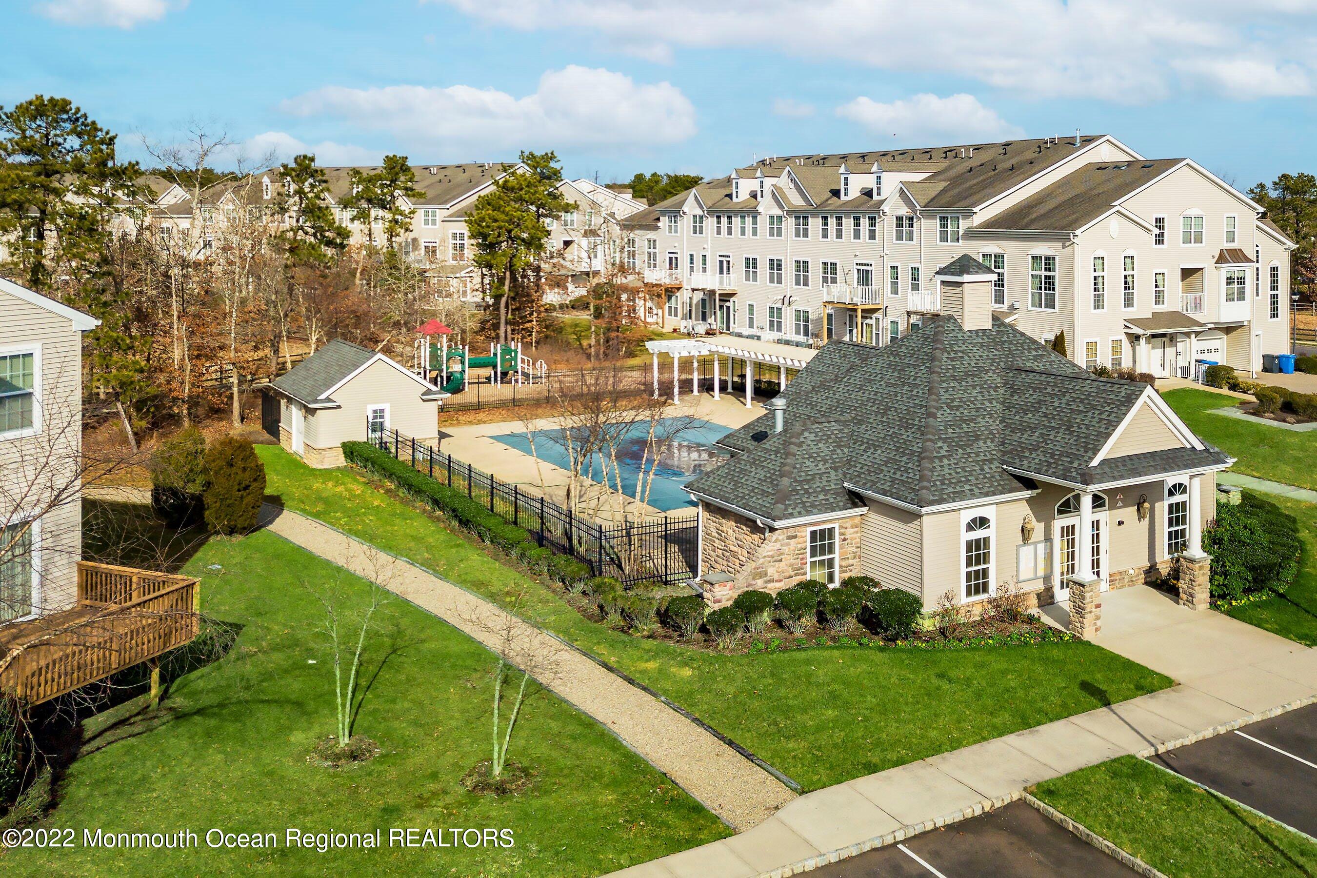 107 Bryce Lane, Unit 2004 Manahawkin, NJ 08050 - Photo 37 of 39 a view of houses with yard and outdoor seating