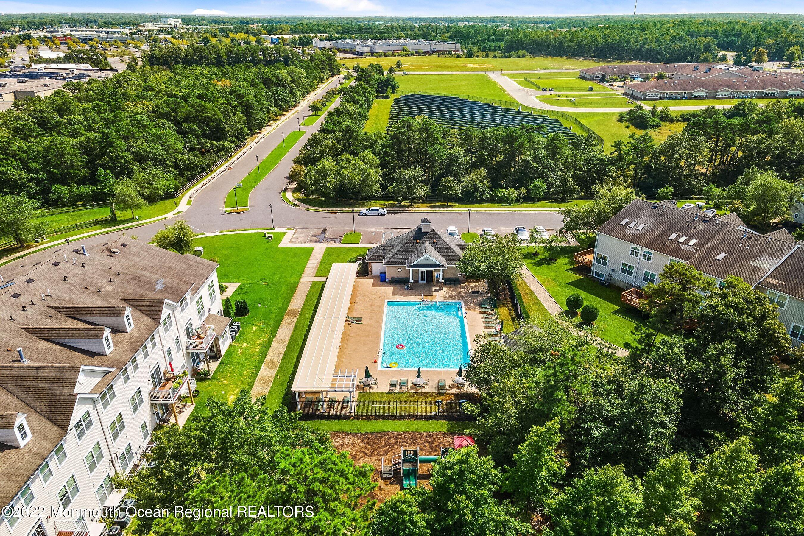 107 Bryce Lane, Unit 2004 Manahawkin, NJ 08050 - Photo 39 of 39 an aerial view of a house with a garden and swimming pool