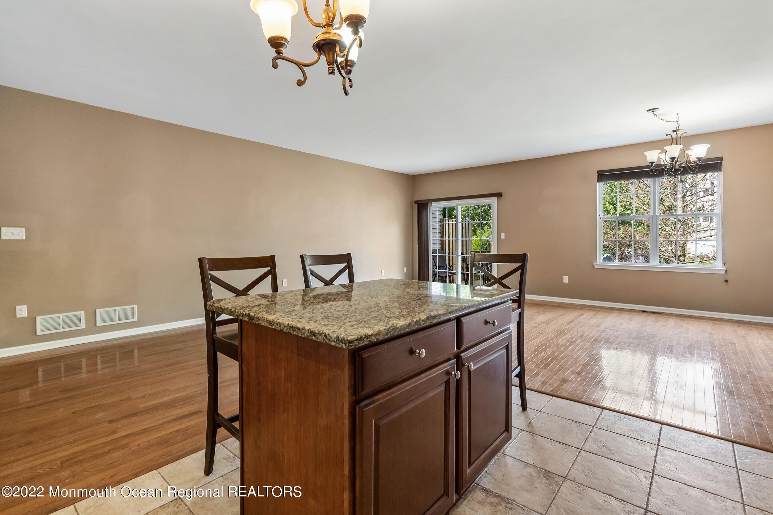 107 Bryce Lane, Unit 2004 Manahawkin, NJ 08050 - Photo 8 of 39 a kitchen with stainless steel appliances granite countertop a stove a sink and a microwave