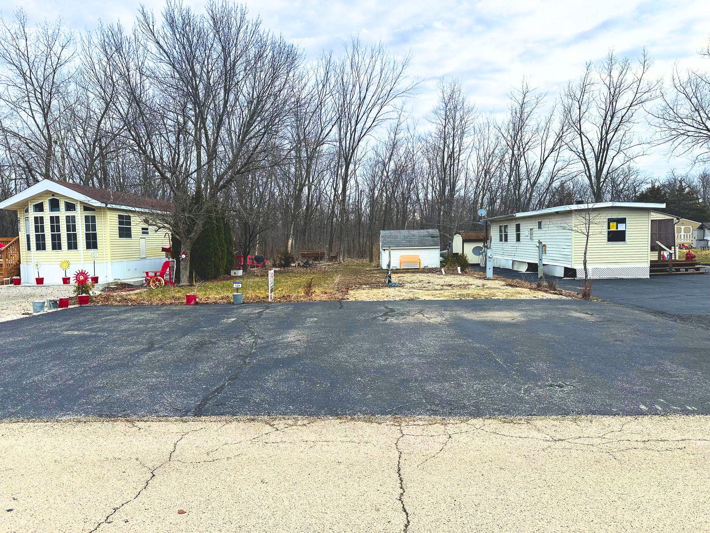 a view of a white house with a yard covered in snow