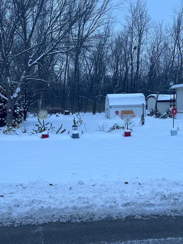 a view of backyard with a table and chairs