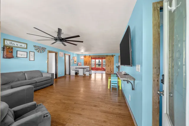 a living room with a table or chairs and a chandelier