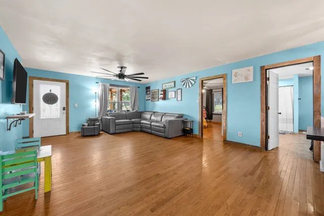 a view of a living room and kitchen with a large window