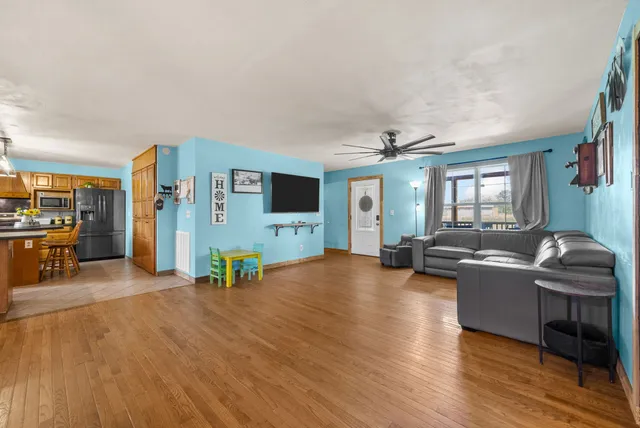 a kitchen with stainless steel appliances wooden cabinets a stove a refrigerator and a sink with granite countertops