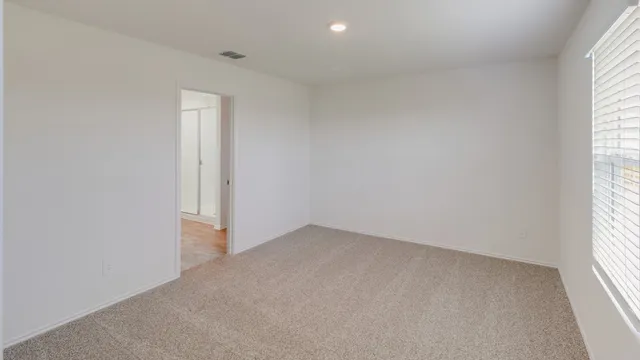 an empty room with windows and closet