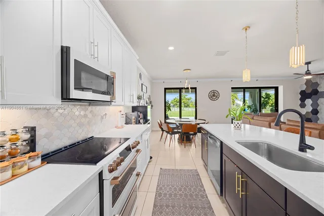 a kitchen with a sink stove and microwave