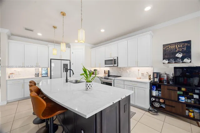 a kitchen with a table chairs microwave and cabinets