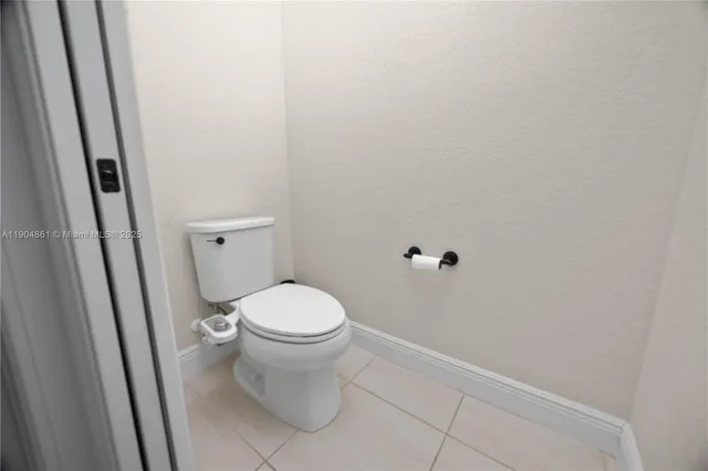 a white toilet sitting next to a shower