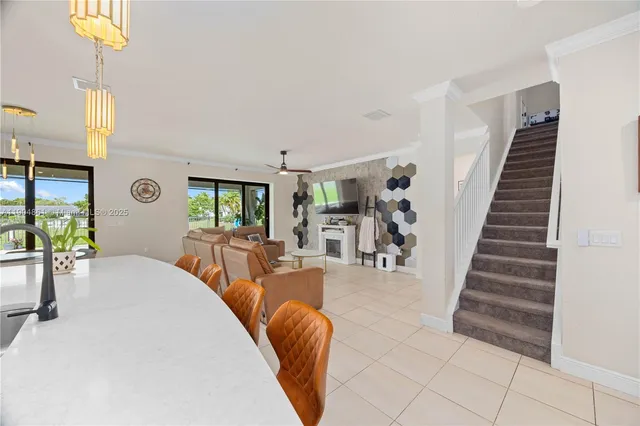 a view of a livingroom with furniture and staircase
