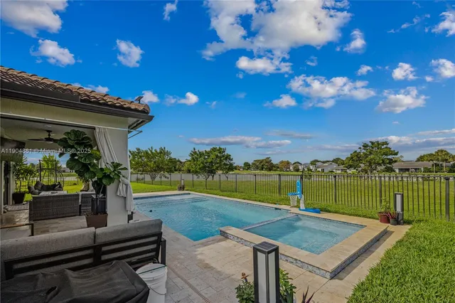a view of a house with backyard and sitting area