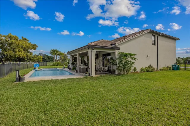 a view of a house with backyard porch and sitting area