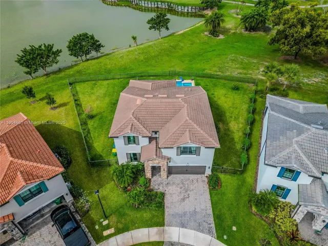 an aerial view of a house with a yard