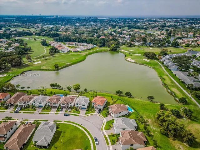 an aerial view of residential houses with outdoor space